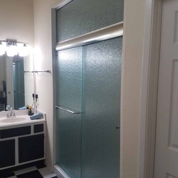 A decorative glass shower door