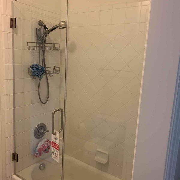 A simple shower area with white tile
