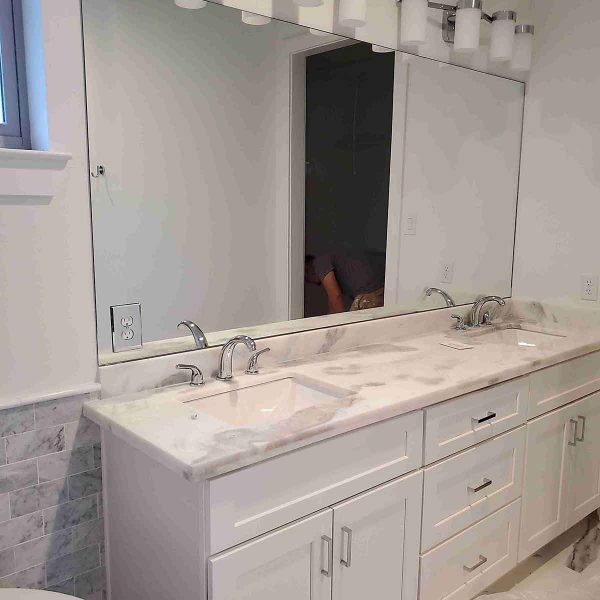 A huge mirror installed in the bathroom area