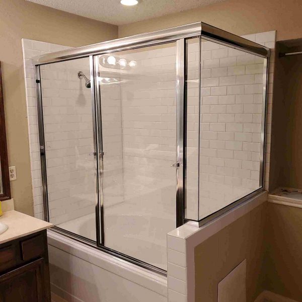 A simple shower area with white wall
