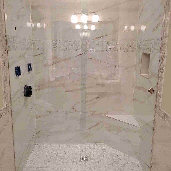 A simple glass door shower area