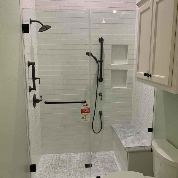 A simple shower area with white wall