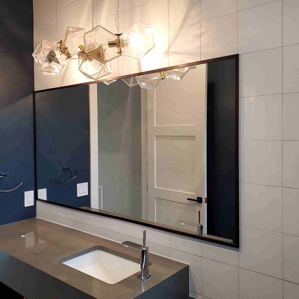 A huge mirror installed in modern style bathroom