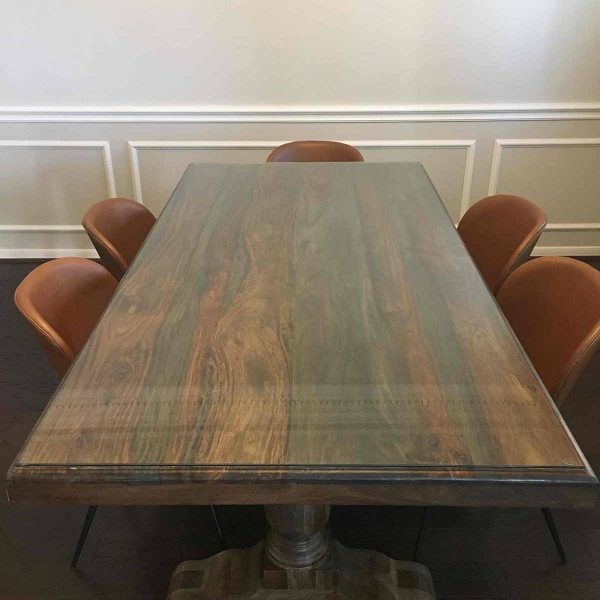 A wooden table top with five chairs