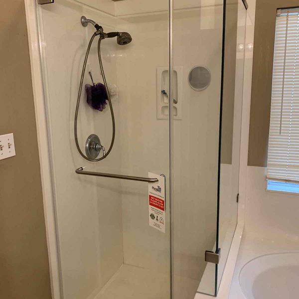 A simple shower area with glass door