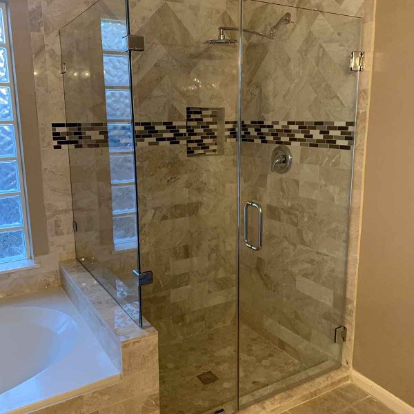 A cornered shower area with glass door