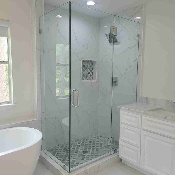 A cornered shower area with glass door