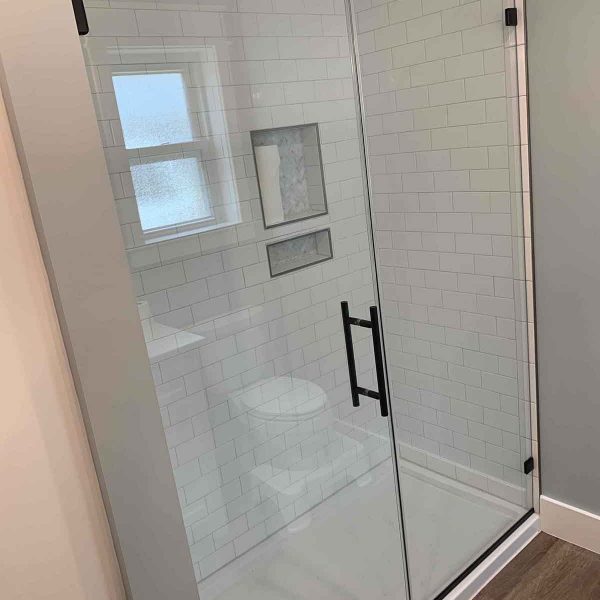 A shower area with white wall