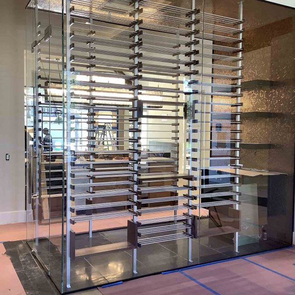 A wine room with a glass wall