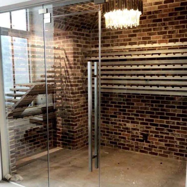 A glass door with brick wall area