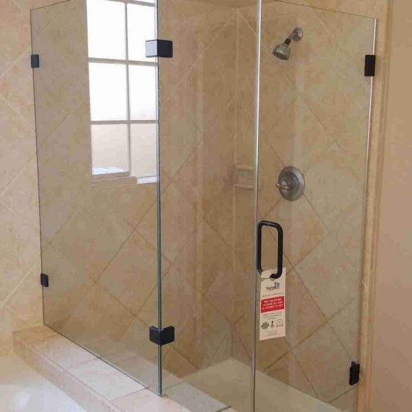 A modern cornered shower area with glass door