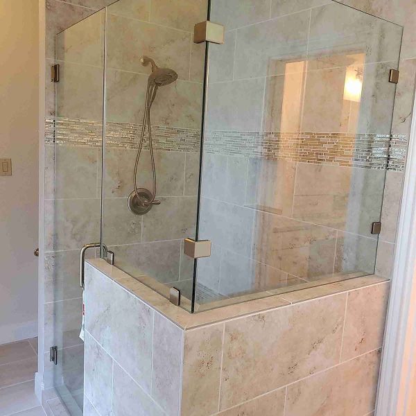 A cornered shower area with glass door