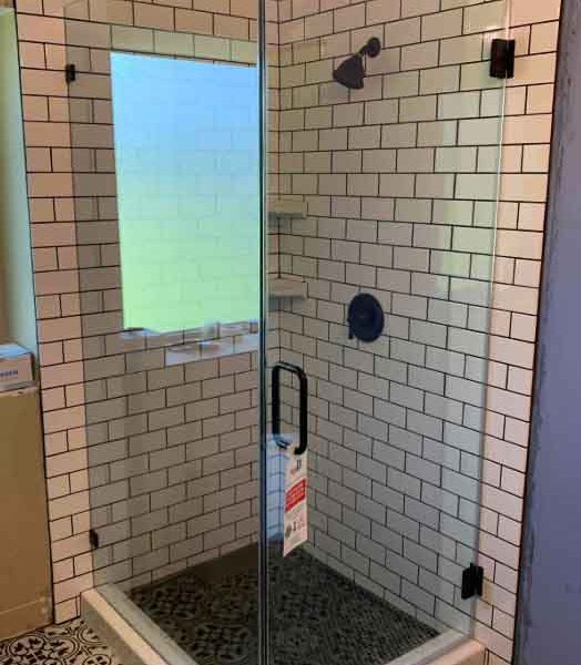 A shower area with white wall